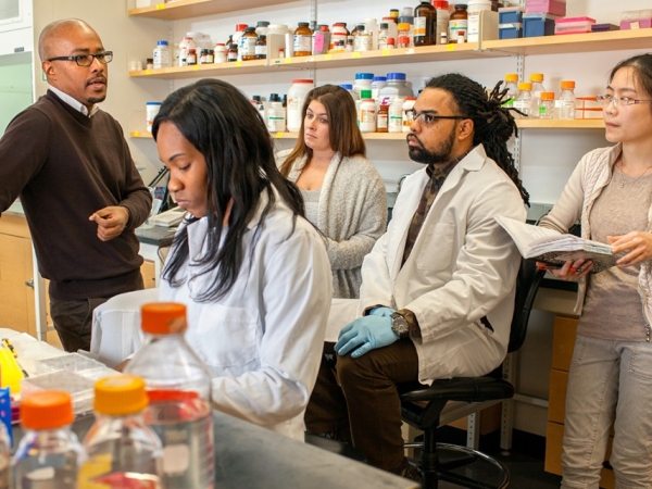 Avery August, Ph.D. ’94, in his immunology lab with members of his research team.